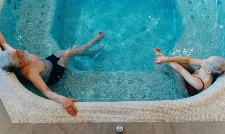 old-couple-lounging-pool