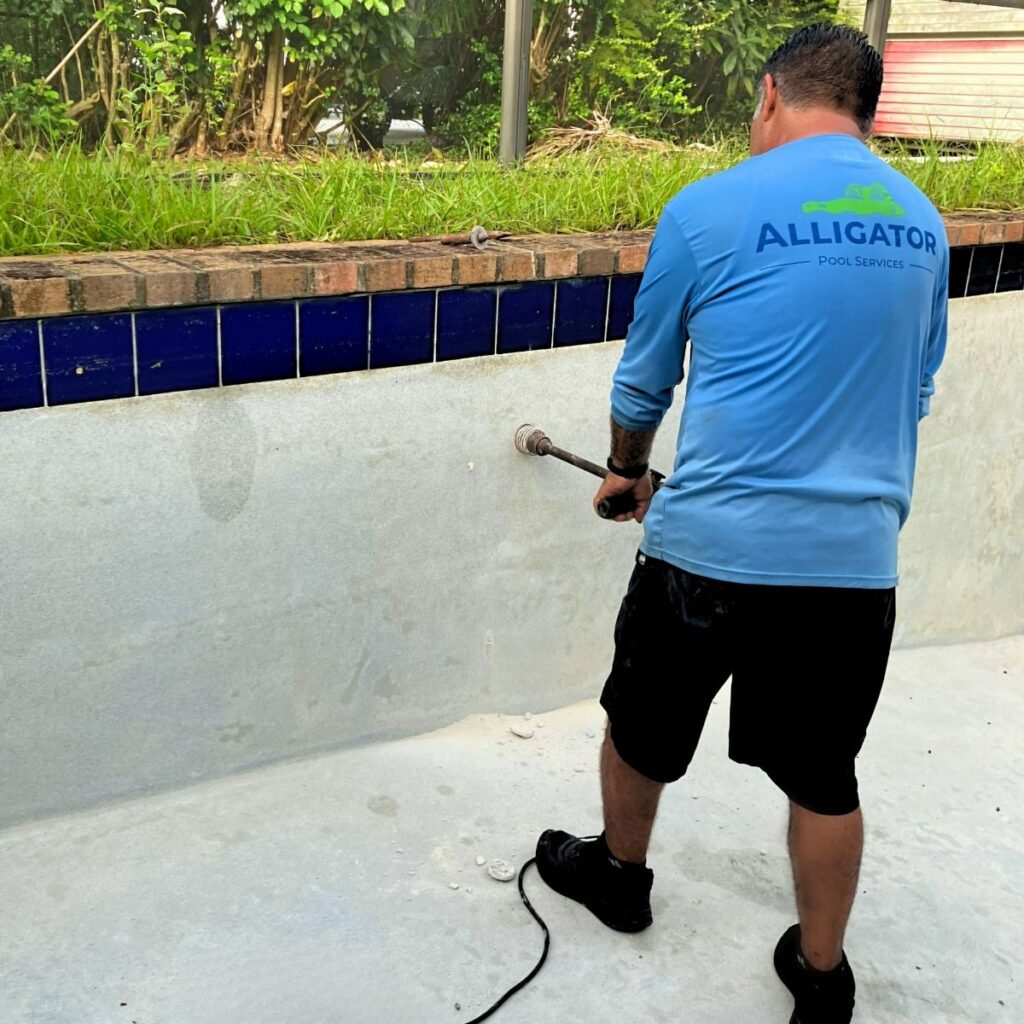 man-drilling-hole-in-pool