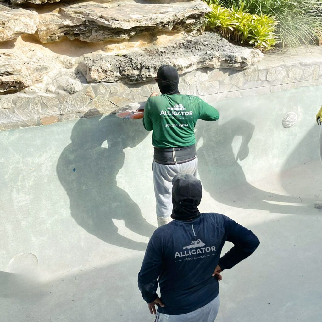 men-repairing-an-empty-pool